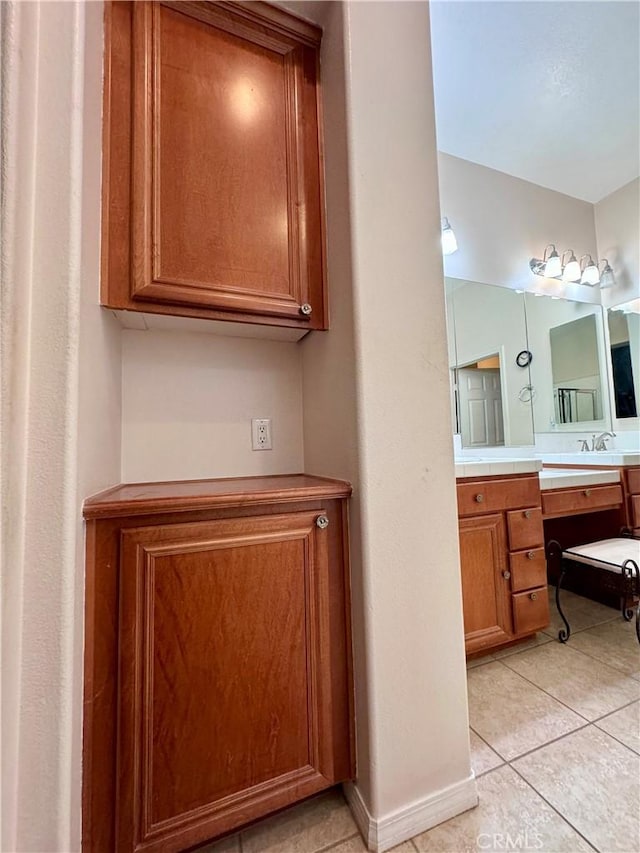 bathroom with tile patterned floors and vanity