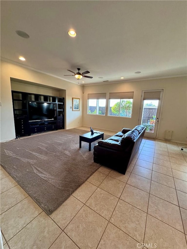 living room with a wealth of natural light, ceiling fan, and light tile patterned flooring