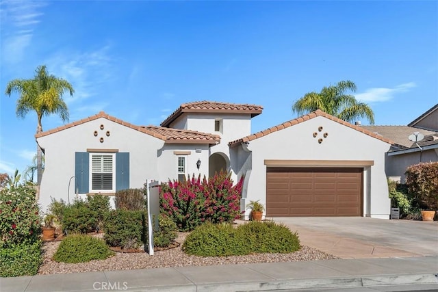 mediterranean / spanish-style house with a garage