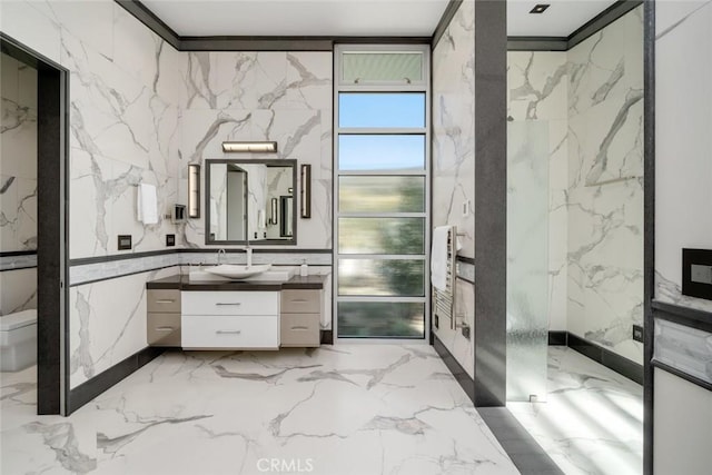 bathroom with toilet, vanity, and crown molding