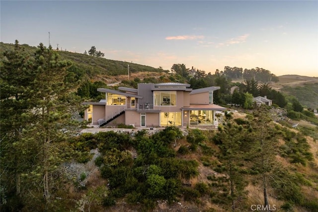 back house at dusk with a mountain view