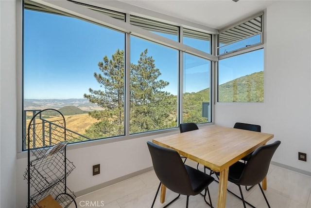 sunroom featuring a mountain view