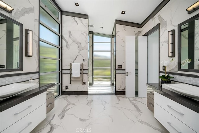 bathroom with tile walls, vanity, and crown molding