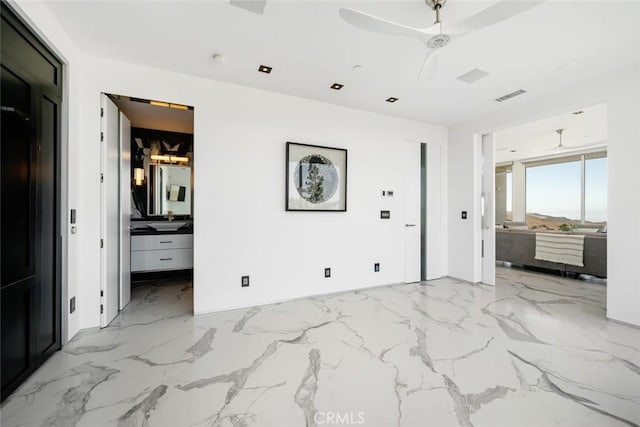 bedroom featuring ceiling fan and ensuite bath