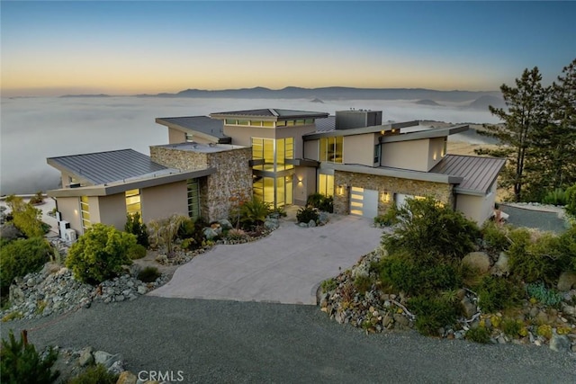 view of front facade with a mountain view and a garage