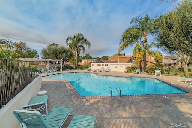 view of swimming pool with a pergola and a patio