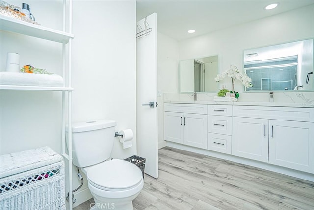 bathroom featuring hardwood / wood-style floors, toilet, and vanity