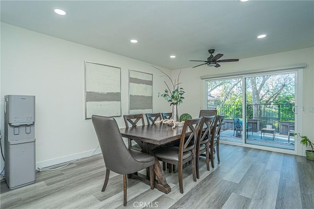 dining space with ceiling fan and light hardwood / wood-style floors