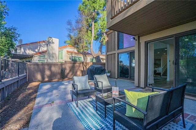 view of patio with grilling area and a balcony