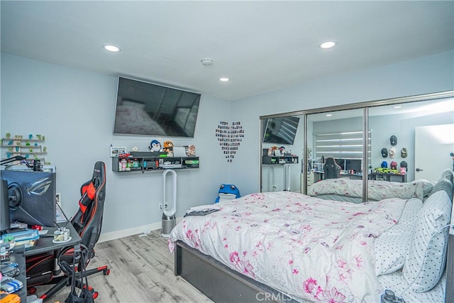 bedroom featuring a closet and light wood-type flooring