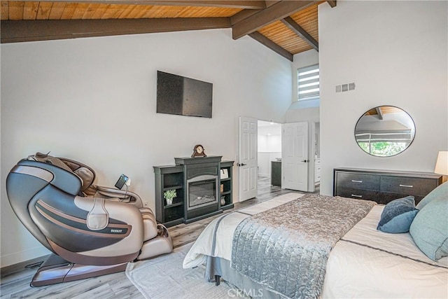 bedroom featuring beam ceiling, light wood-type flooring, wooden ceiling, and high vaulted ceiling