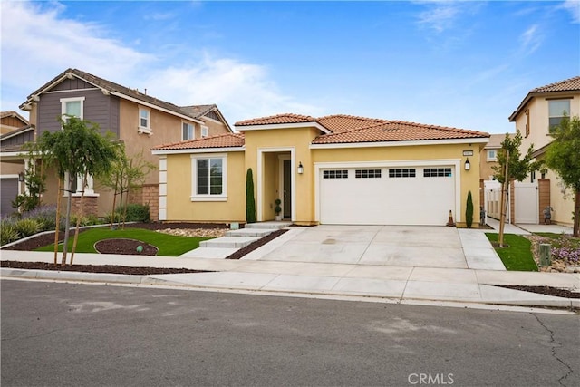 mediterranean / spanish-style house with a garage