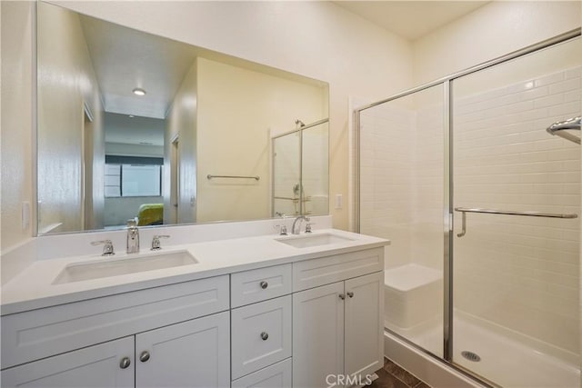 bathroom with a shower with door and vanity