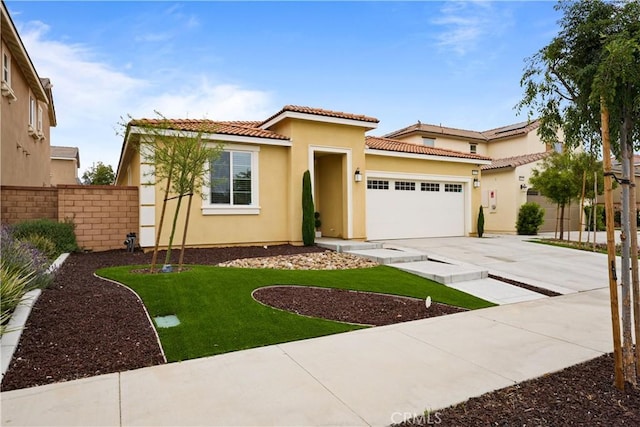 mediterranean / spanish-style home featuring a front lawn and a garage