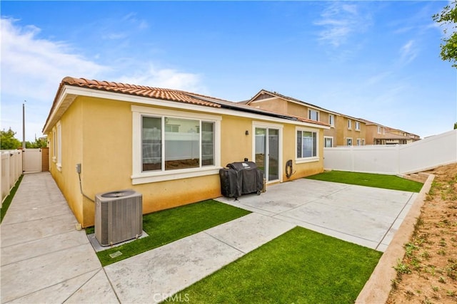 back of property featuring central AC and a patio area