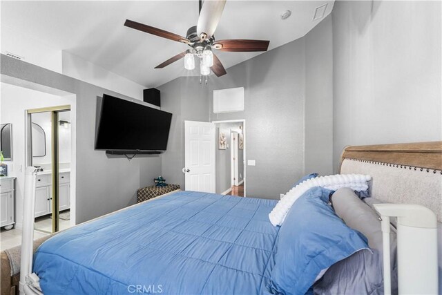 bedroom featuring ceiling fan, ensuite bathroom, and vaulted ceiling