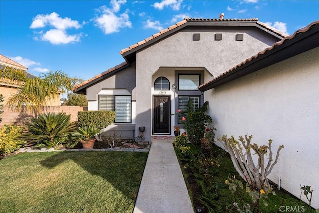 doorway to property featuring a yard