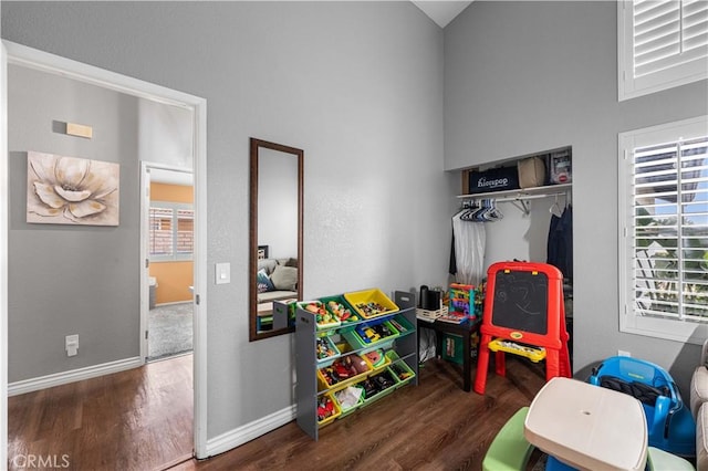 recreation room with dark hardwood / wood-style floors