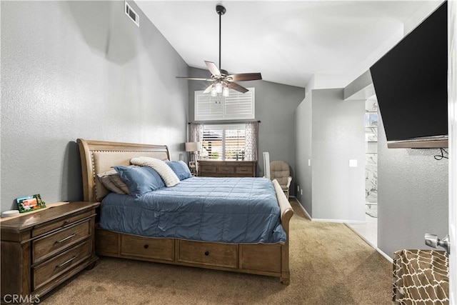 carpeted bedroom with ceiling fan and vaulted ceiling