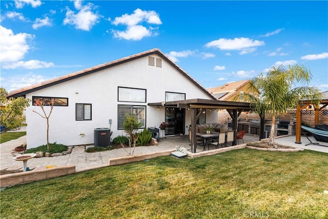 rear view of property featuring cooling unit, a patio, and a yard