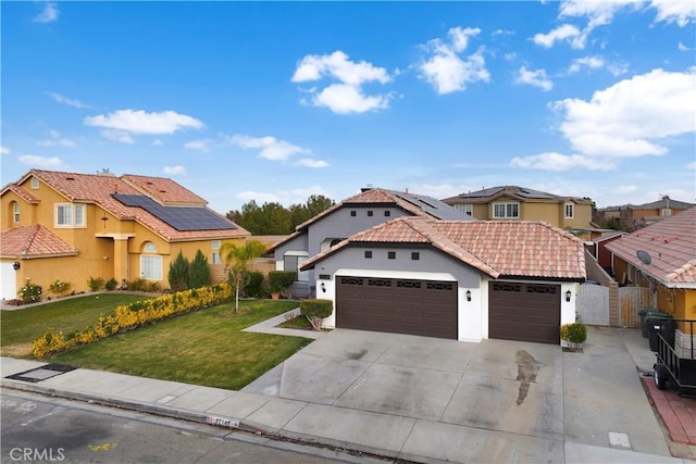 mediterranean / spanish-style house with a front yard and solar panels