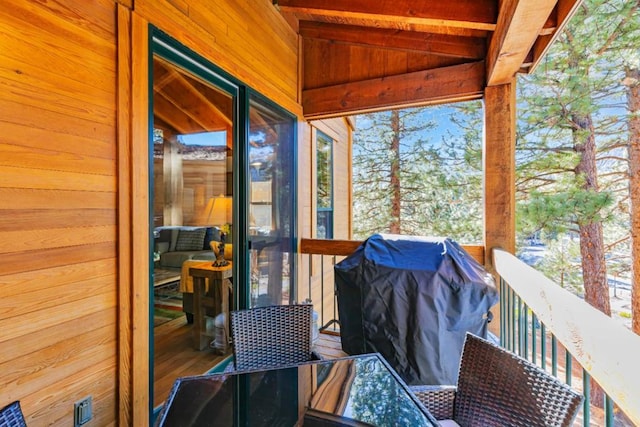 sunroom / solarium featuring lofted ceiling