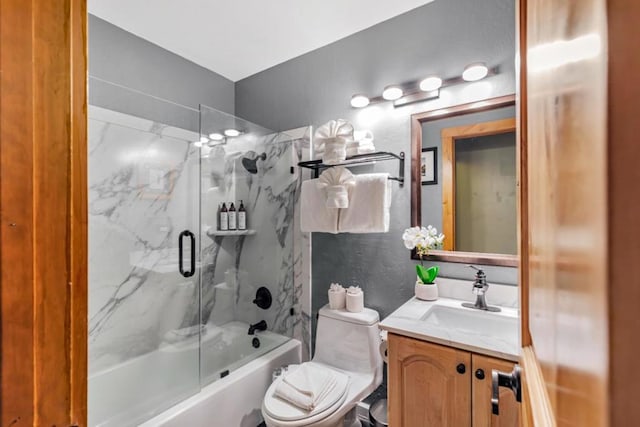 full bathroom featuring toilet, vanity, and tiled shower / bath