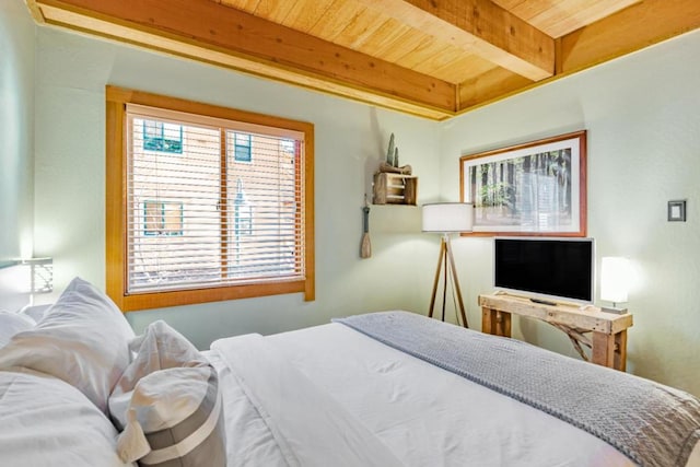 bedroom with beam ceiling and wood ceiling