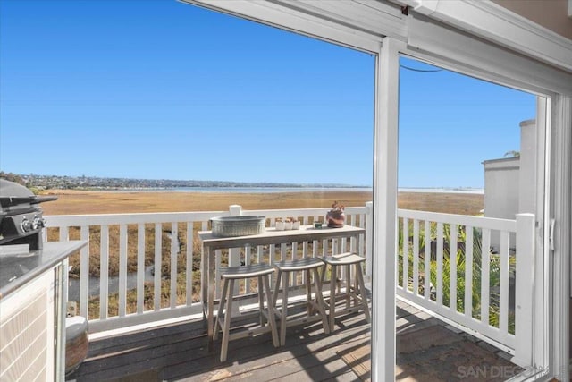 wooden terrace featuring a grill