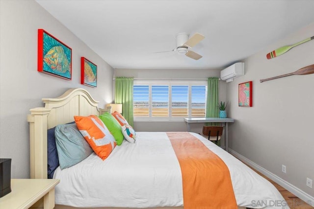 bedroom with an AC wall unit, ceiling fan, and hardwood / wood-style flooring