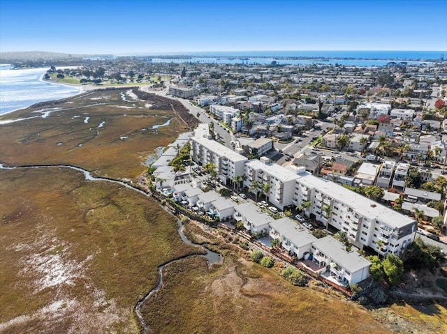 birds eye view of property with a view of the beach and a water view