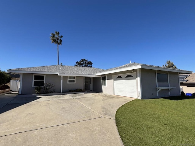 ranch-style house with a garage and a front lawn