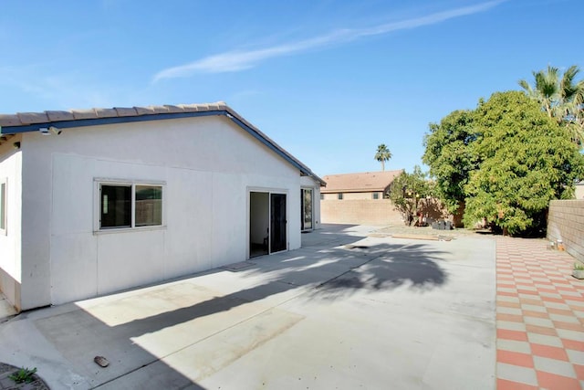 view of side of home with a patio