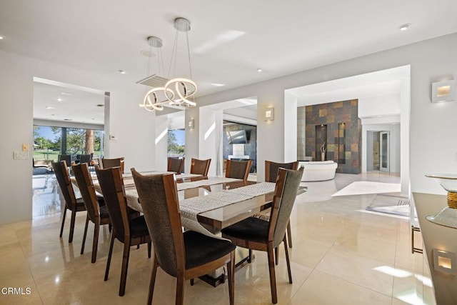 tiled dining room featuring a chandelier