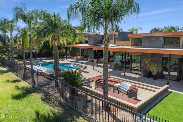 view of swimming pool featuring area for grilling, a patio area, and a lawn