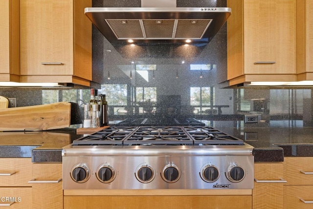 kitchen featuring light brown cabinetry, gas stovetop, range hood, and tasteful backsplash