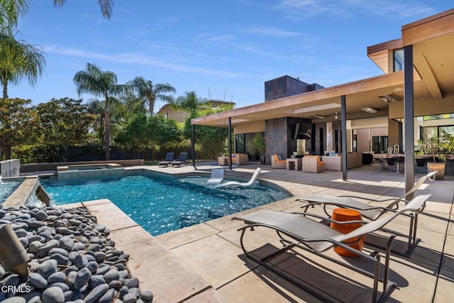 view of swimming pool with an outdoor hangout area, a patio area, and an in ground hot tub