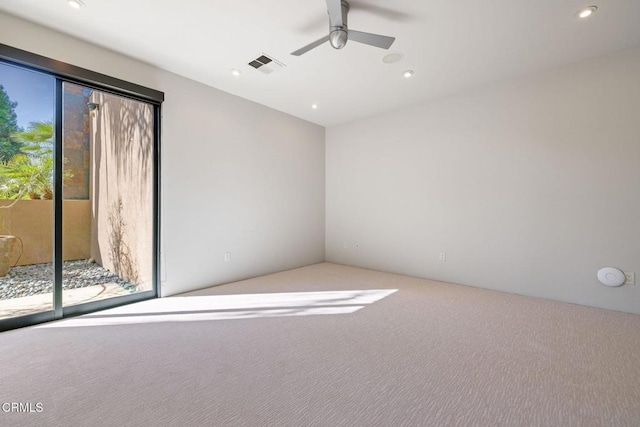 carpeted spare room with ceiling fan and a healthy amount of sunlight