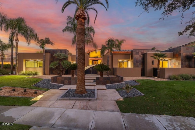 view of front of property with a lawn