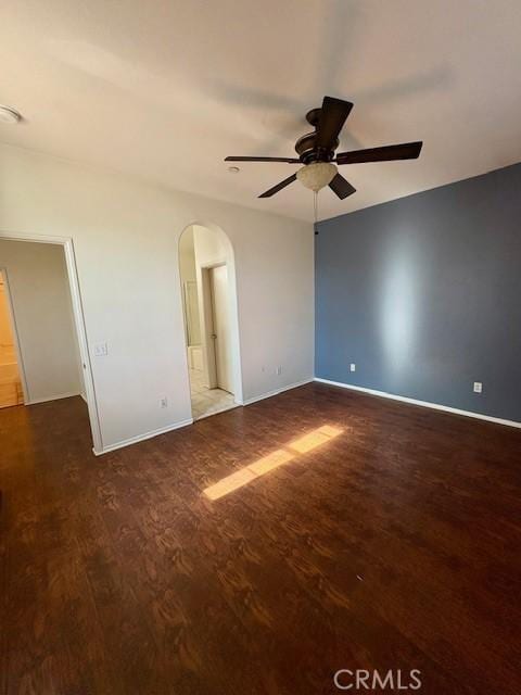 unfurnished room with ceiling fan and dark hardwood / wood-style floors