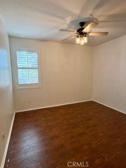 unfurnished room featuring ceiling fan and dark wood-type flooring