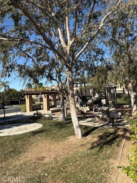 view of home's community with a playground and a lawn