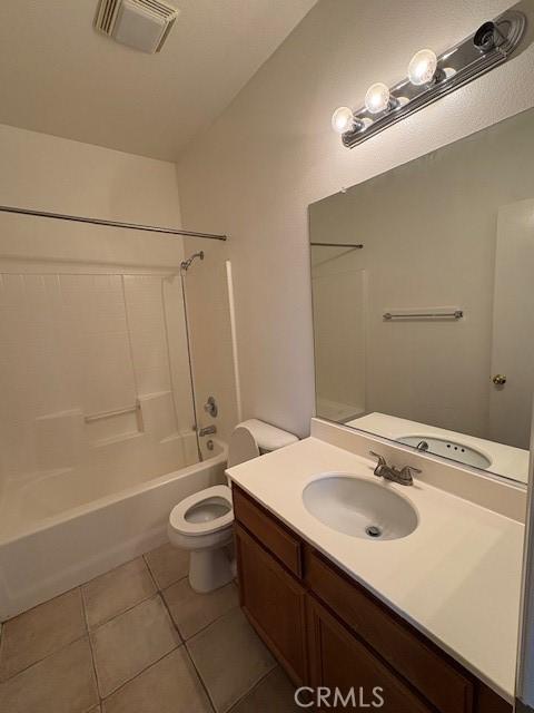 full bathroom with vanity,  shower combination, tile patterned floors, and toilet