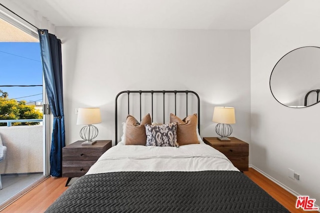 bedroom featuring multiple windows and light hardwood / wood-style floors