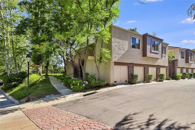 multi unit property featuring a garage