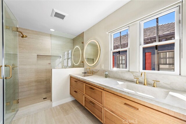 bathroom featuring an enclosed shower and vanity