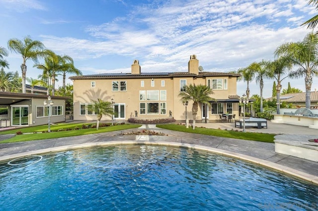 view of swimming pool featuring a patio and a water view