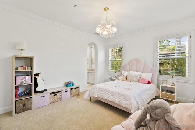 carpeted bedroom with ensuite bath, an inviting chandelier, and crown molding