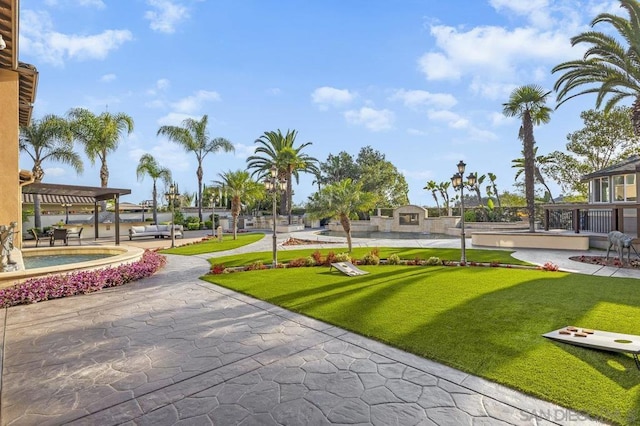 surrounding community featuring a lawn and a pergola