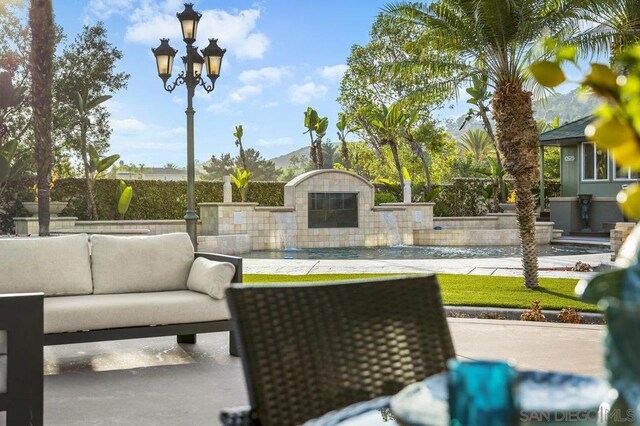 view of patio featuring outdoor lounge area and a mountain view